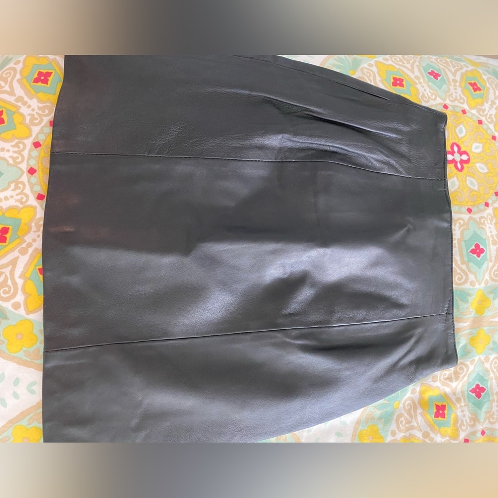 Wilson, black, leather mini skirt size tag says size 6 but it’s between 2&4.